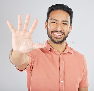 Buy stock photo Smile, hand and portrait of man with stop gesture happy for communication isolated in a studio white background. Asian, sign language and confident young person with signal, symbol and hello sign