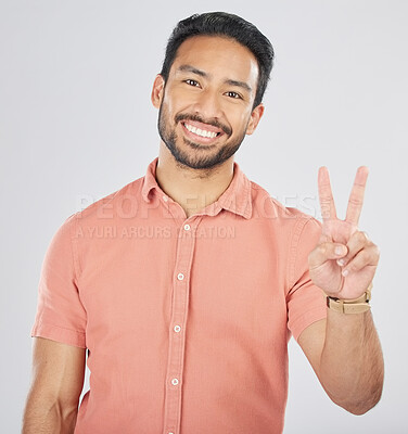 Buy stock photo Peace, hands and portrait of happy man in studio for thank you, vote or feedback on grey background. V, sign and Japanese guy face with good vibes, smile or freedom emoji, support or self love