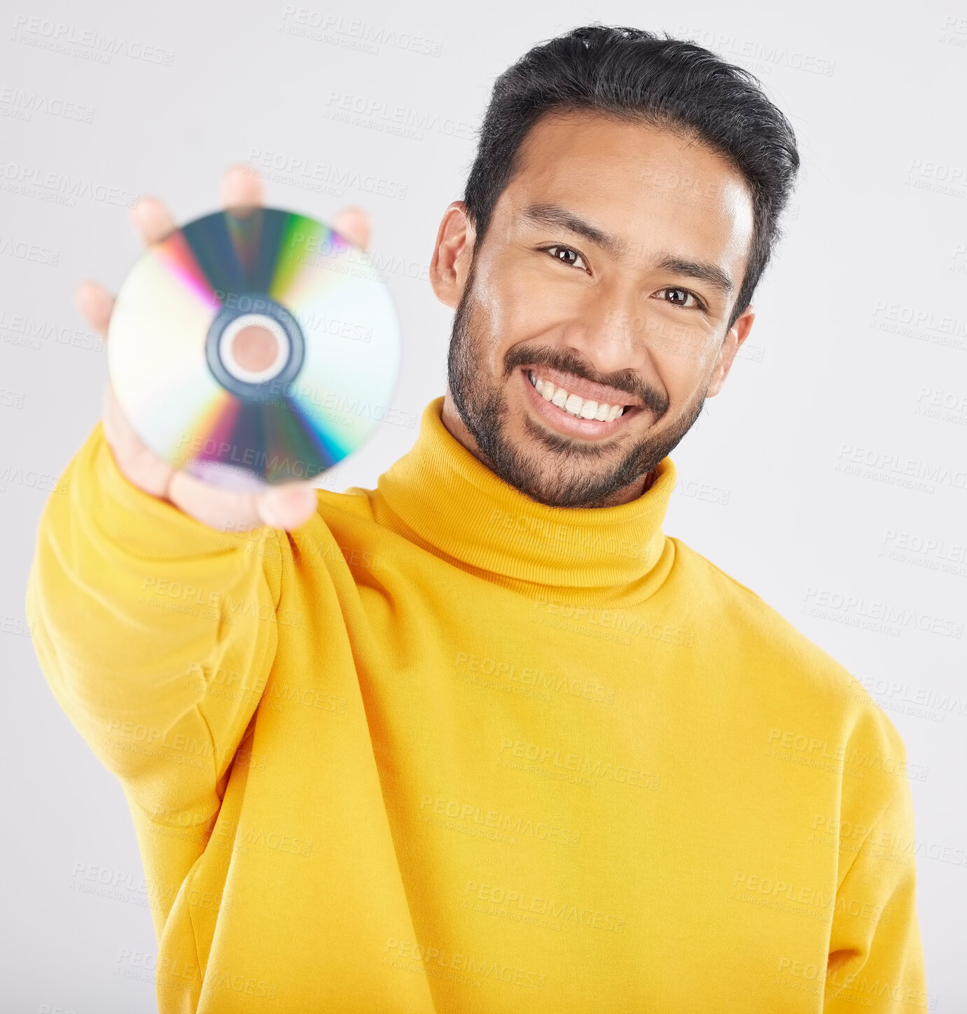 Buy stock photo Man, cd and smile in studio portrait for music, tech or software for data, info or sound by white background. Student guy, happy model and retro disk storage or dvd for film, multimedia or movie