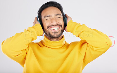 Buy stock photo Man, headphones and excited for listening in studio, smile or hearing with streaming subscription by white background. Indian guy, student or fashion model with audio, music or happy for online radio