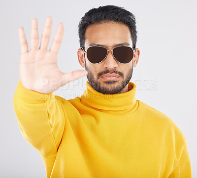 Buy stock photo Man, palm and stop in sunglasses, studio portrait or emoji for opinion, rejection or no by white background. Indian guy, student or fashion model with hand, sign language and show gesture for review