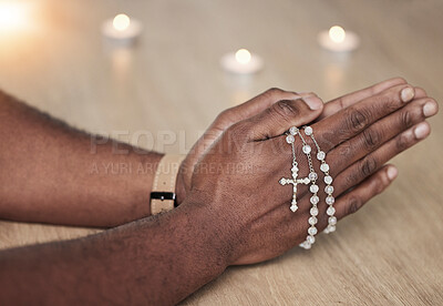 Rosary, man hand and cross prayer beads in a home with hope, christian praise and religion. Praying, necklace and worship in a house with god, gratitude and spiritual guide for support and healing