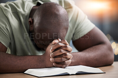 Bible, hands praying and man with book and religion study at home for worship and spiritual support. Faith, christian knowledge and person with gratitude, scripture education and guidance in a house
