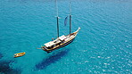 Yacht, sailing in Croatia and sun on ocean holiday, relax in freedom and nature with clean blue water from above. Boat vacation, travel in summer and tropical cruise on sea adventure with island fun.