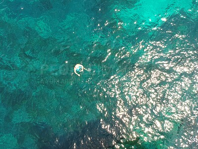 Buy stock photo Above, swimming and a person in the ocean in summer for a beach vacation, travel or relax in the water. Nature, sunshine and a man in the sea for stress relief, holiday or happy with a drone view