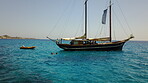 Yacht, sailing in Greece and summer on ocean holiday, relax in freedom and nature on blue water. Boat vacation, travel in sun and tropical cruise on sea adventure to island coast in beach transport.