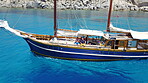 People on wooden boat, sailing in Greece and summer sun on ocean holiday, relax in freedom and nature. Yacht vacation, family travel and tropical cruise on sea adventure to Greek island on blue water