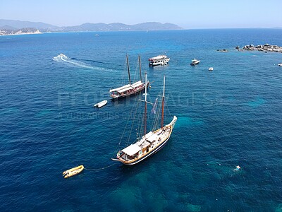 Aerial boat, sailing in Greece and summer sun on ocean holiday, relax in freedom and nature. Yacht vacation, travel and tropical cruise on sea adventure tour to Greek island on blue sky and water.