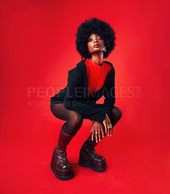 Buy stock photo Black woman, makeup and afro, hair and fashion in portrait with shine isolated on red background. Hairstyle, haircare and texture with growth, stylish clothes and confident African model in a studio