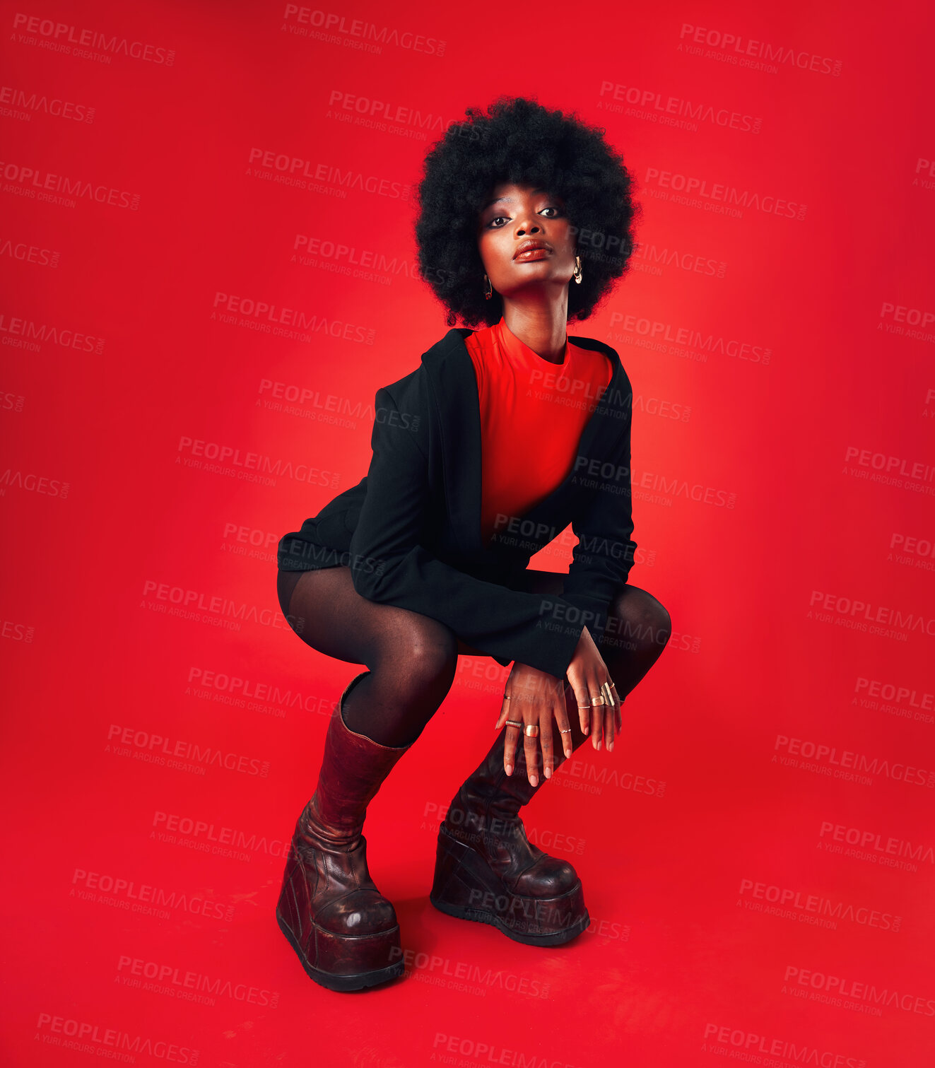 Buy stock photo Black woman, makeup and afro, hair and fashion in portrait with shine isolated on red background. Hairstyle, haircare and texture with growth, stylish clothes and confident African model in a studio