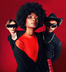 Fashion, portrait and a group of people, style and retro clothes on a red studio background for art, punk and creative aesthetic. Friends, rock or a black woman with men with vintage outfit or trendy