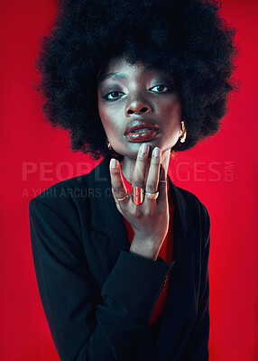 Buy stock photo Black woman, portrait and afro, hair and beauty with makeup and shine isolated on red background. Hairstyle, haircare and texture with growth, face skin glow and confident African model in a studio