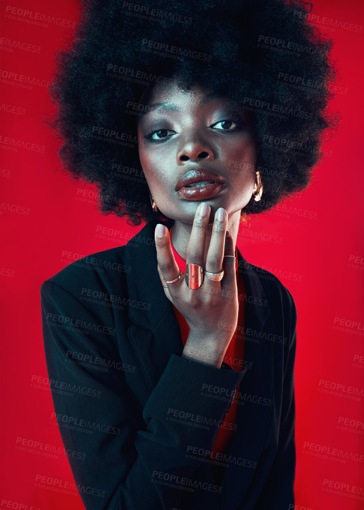 Buy stock photo Black woman, portrait and afro, hair and beauty with makeup and shine isolated on red background. Hairstyle, haircare and texture with growth, face skin glow and confident African model in a studio