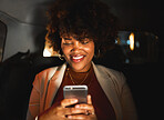 Black woman, afro and phone at night in taxi, travel or communication in social media or networking. Happy African female person smile in online chatting or late evening on mobile smartphone in car