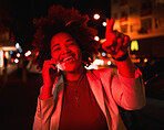 Businesswoman, phone call in street and city lights in the night, smile and pointing while waiting for taxi. Smartphone, neon red lighting and happy black woman in road with networking conversation.