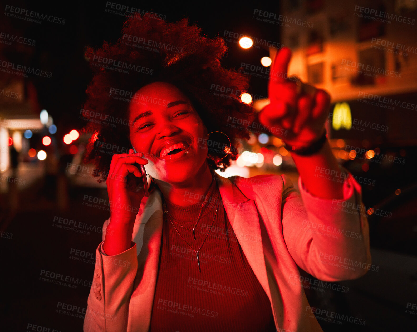 Buy stock photo Businesswoman, phone call in street and city lights in the night, smile and pointing while waiting for taxi. Smartphone, neon red lighting and happy black woman in road with networking conversation.