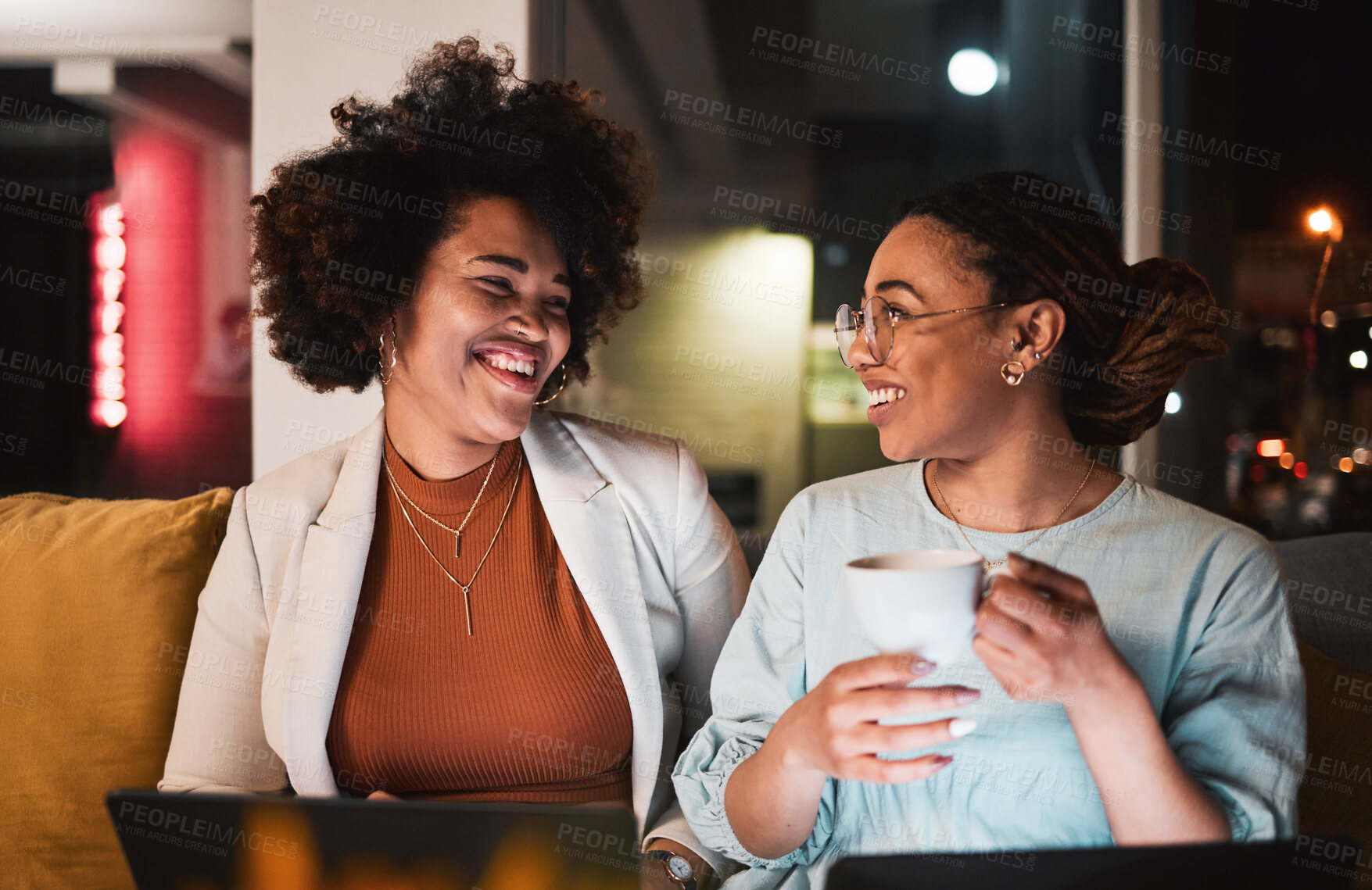 Buy stock photo Women, happy and talking at night for teamwork, collaboration and working late in office. Communication, deadline and entrepreneur people or friends with laptop and coffee while brainstorming ideas
