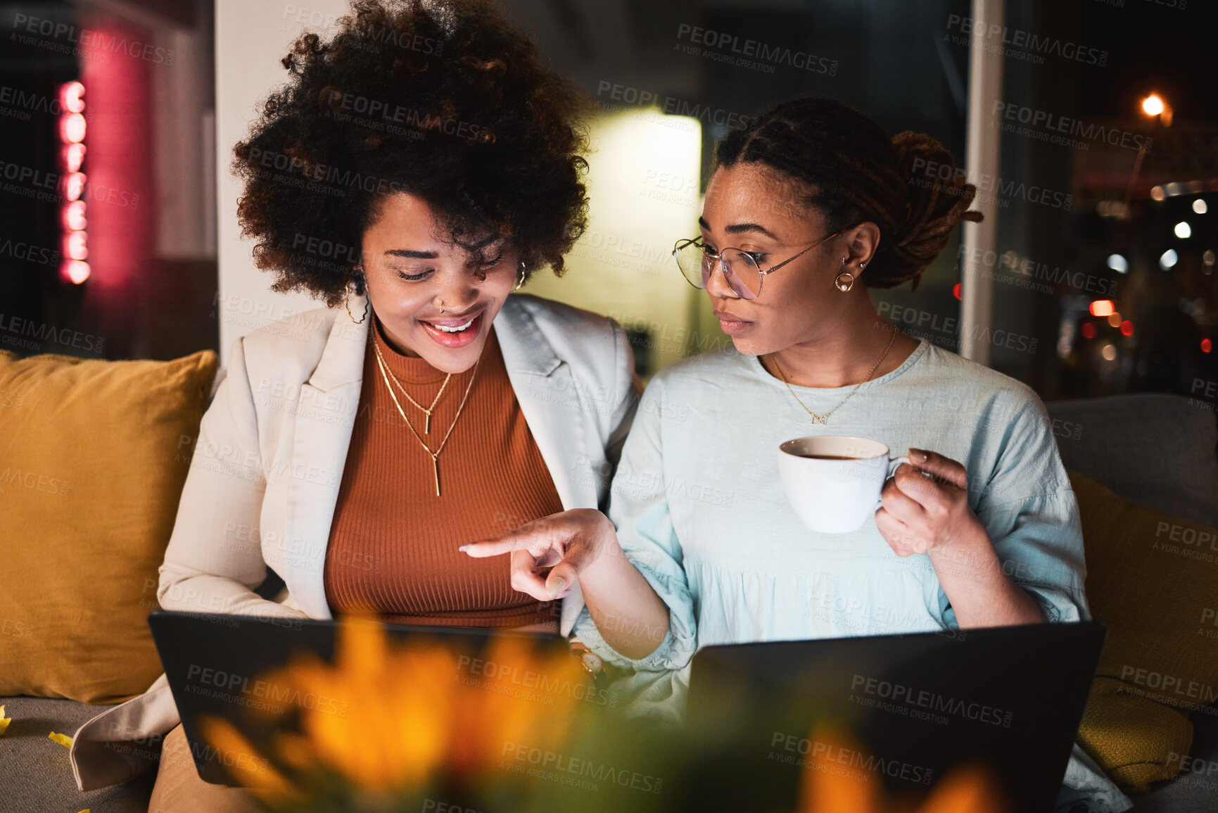 Buy stock photo Women, coffee and laptop at night for teamwork, collaboration and working late in office. Communication, deadline and entrepreneur people talking, planning and brainstorming ideas with a partner