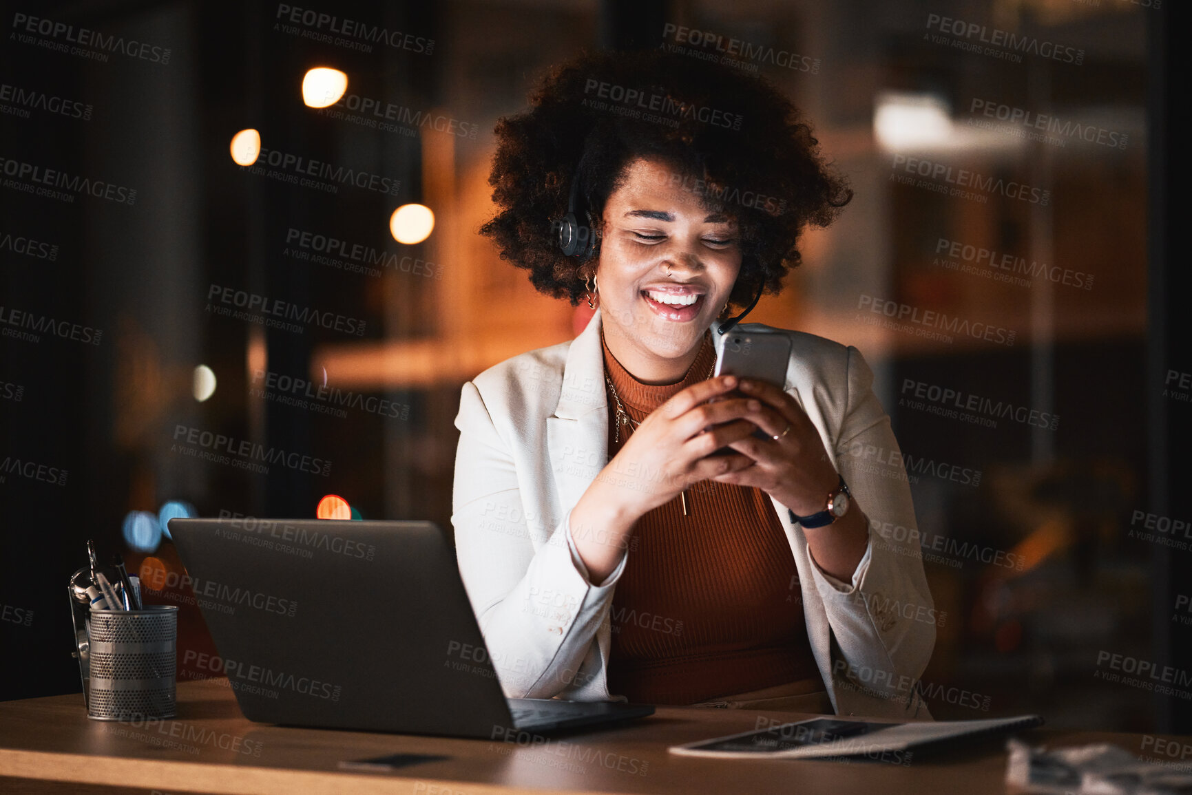 Buy stock photo African, business woman and reading with phone at night working in office with social media, meme or funny email. Contact, communication and happy employee online in Kenya networking with cellphone