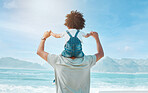 Back, piggyback and a man with his daughter on a beach, looking at the view together on holiday or vacation. Summer, freedom and family with a man carrying his girl child on his shoulders by the sea