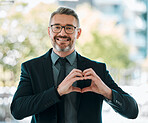 Portrait, business man and heart hands outdoor for care, kindness or love emoji for peace. Happy mature executive entrepreneur with finger shape for thank you, trust and like icon for support in city