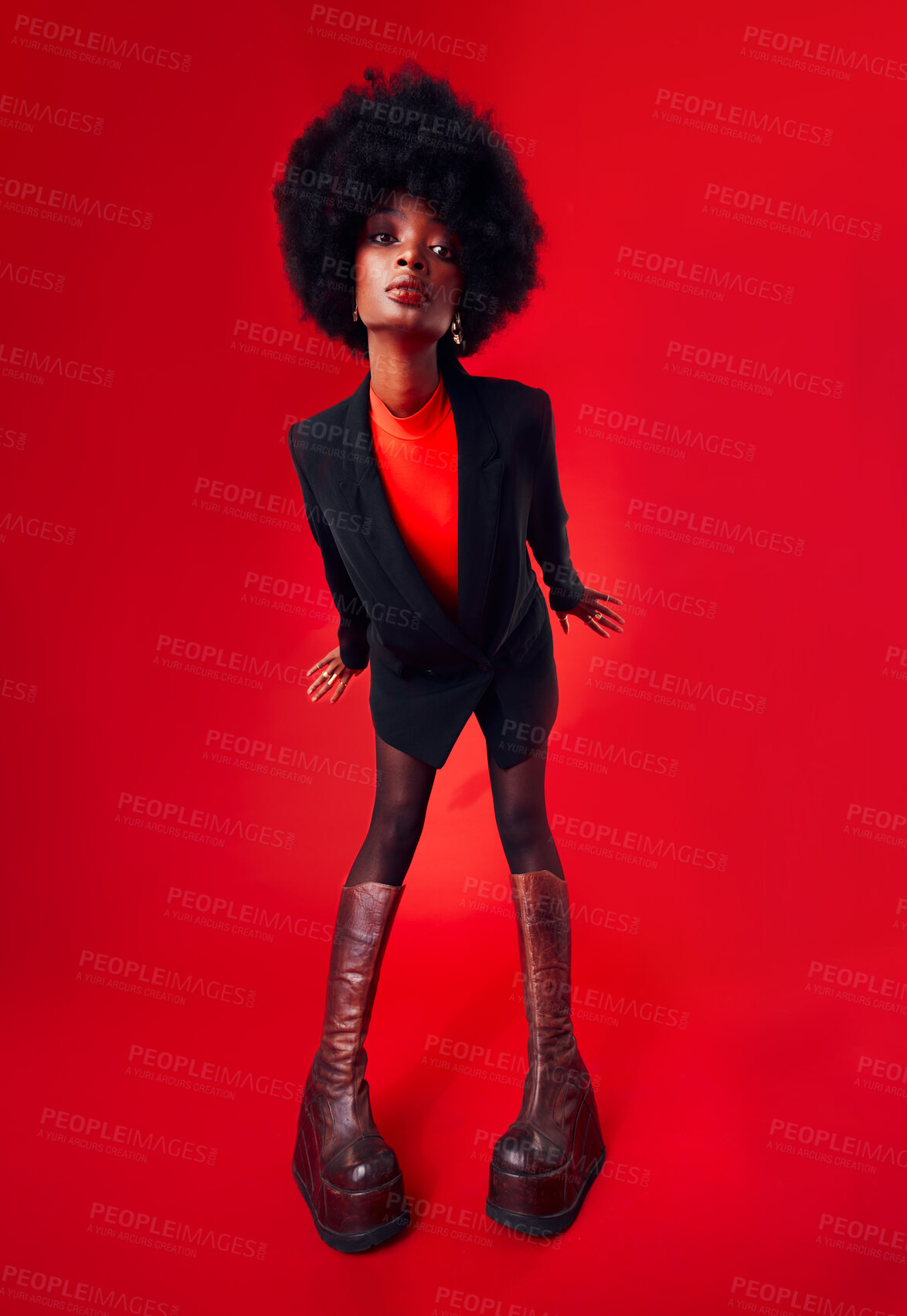 Buy stock photo Black woman, afro and hair with fashion and style, edgy with designer clothes and gen z isolated on red background. Mockup space, stylish clothing and trendy African model with hairstyle in a studio