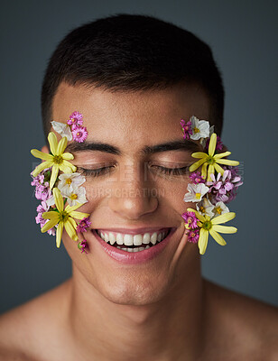 Buy stock photo Face, happy man and flowers, beauty and natural, cosmetics and art deco isolated on studio background. Nature aesthetic, smile in portrait and dermatology, eco friendly skincare and clean with spring