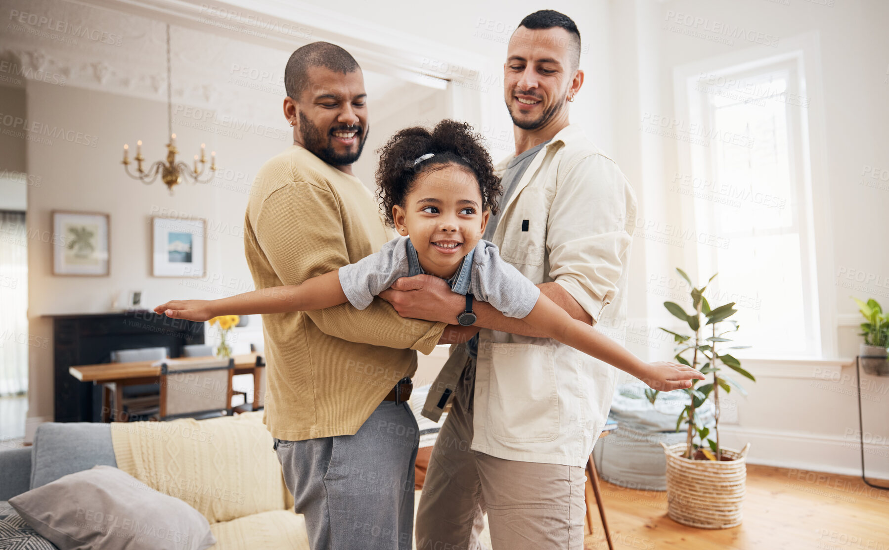 Buy stock photo Happy family, gay parents and girl flying in home or playing, holding kid as a plane, lifting or bonding in fun living room game. LGBT, father and dad support child together in the air or lounge