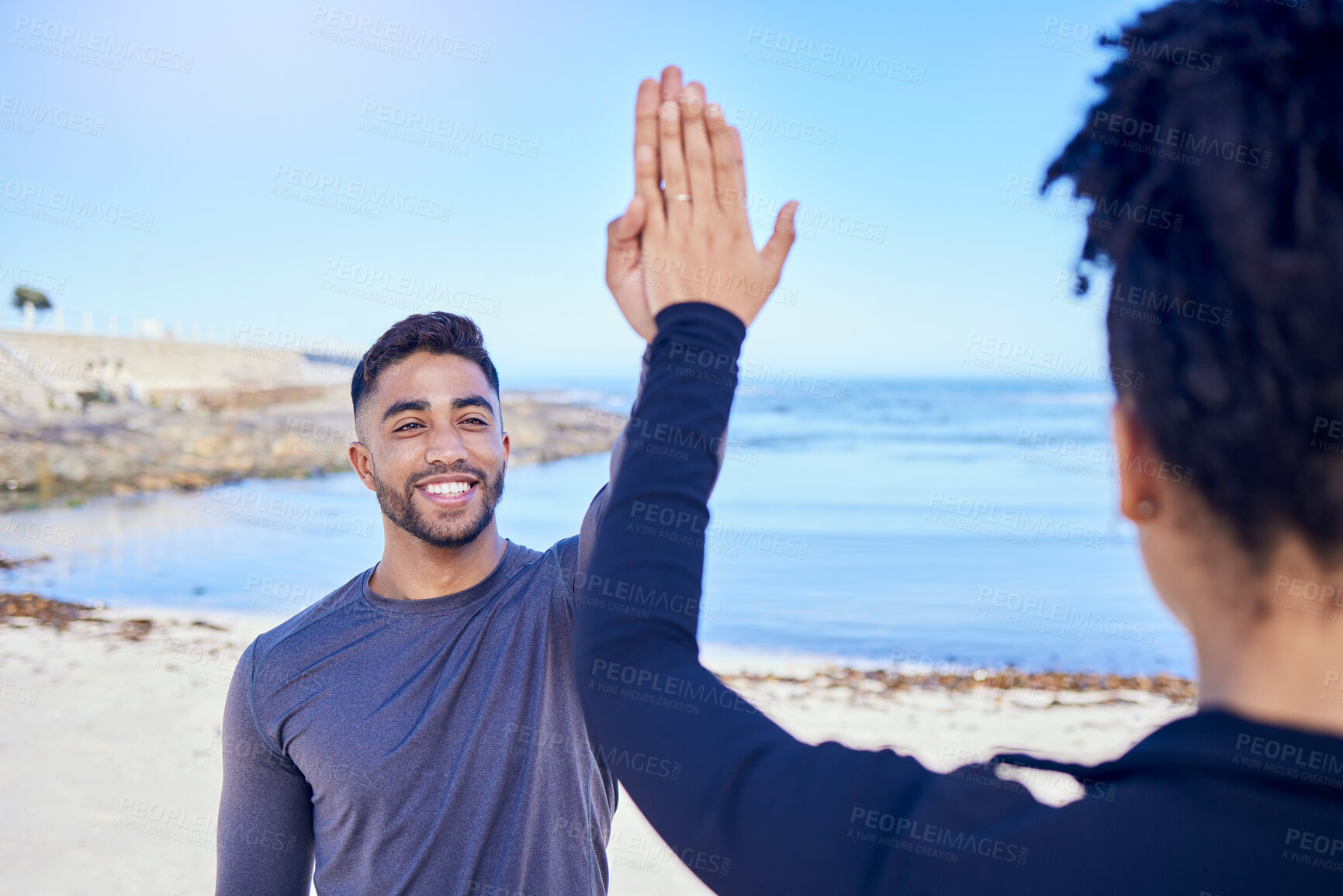 Buy stock photo Fitness, couple and high five on the beach for exercise, outdoor workout or training for water sports, teamwork and healthy cardio. Happy, man and woman athlete with motivation or support in winning 