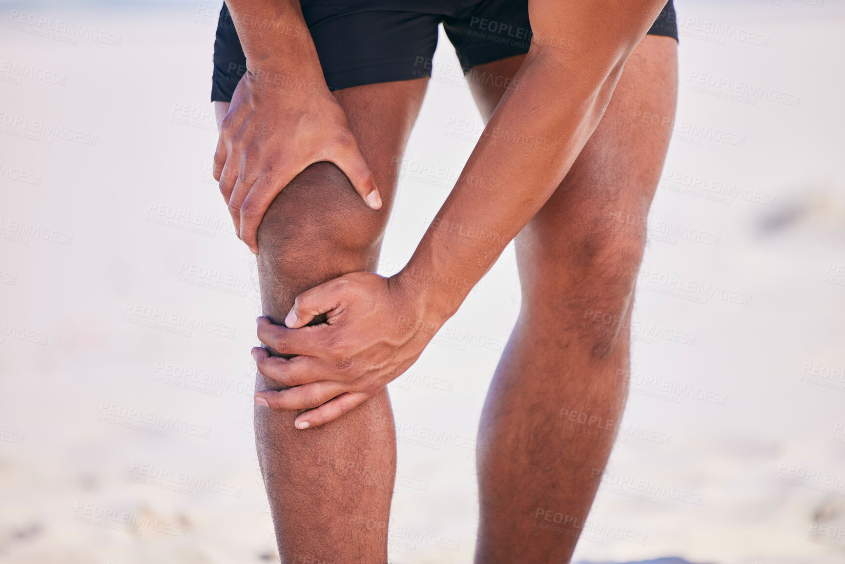 Buy stock photo Hands, knee pain and athlete at beach, accident and fitness exercise in sport workout outdoor. Legs, injury and arthritis of man, muscle problem and fibromyalgia in medical emergency for osteoporosis