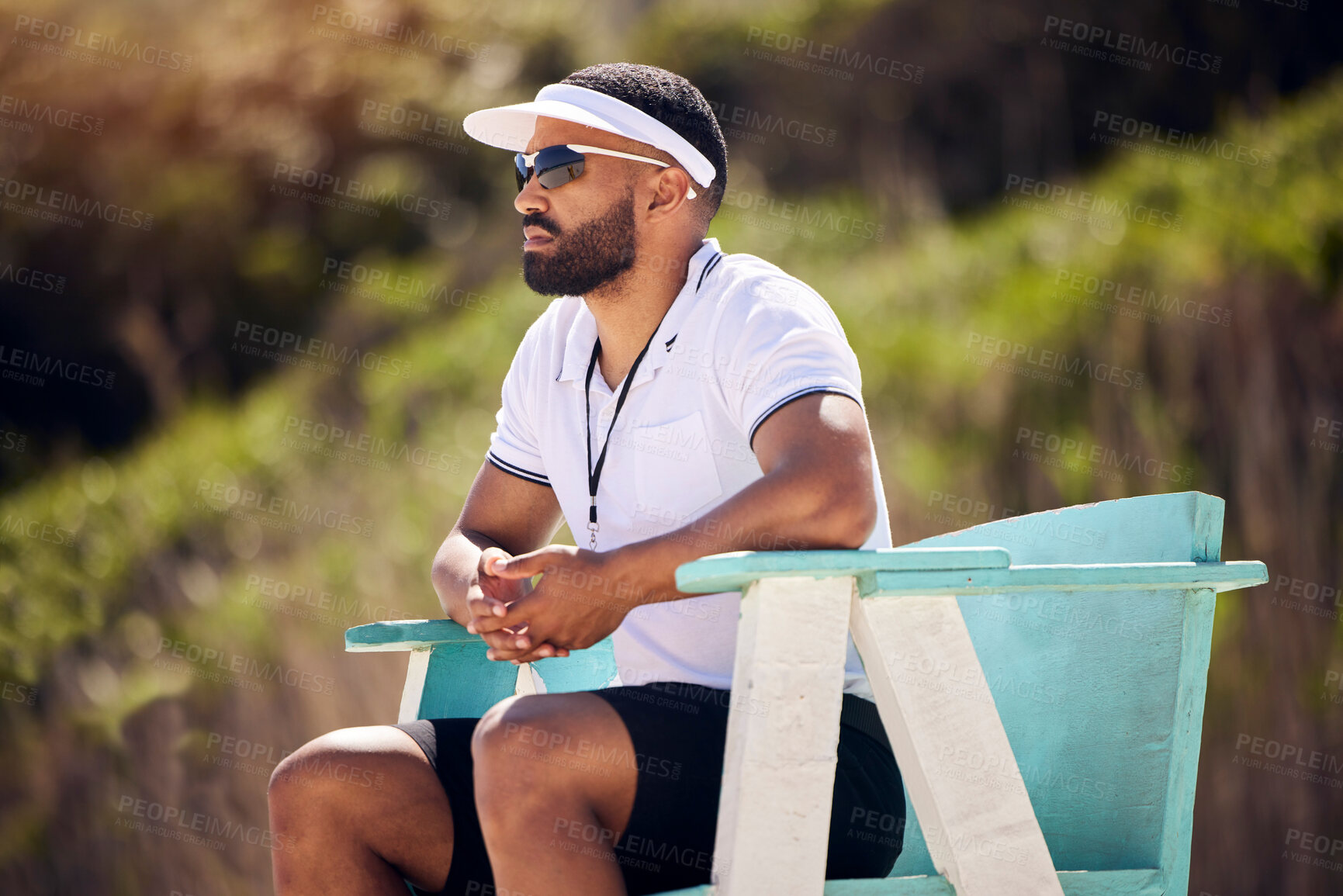 Buy stock photo Summer, sports and a volleyball referee in a chair on the beach for authority, rules or regulations during a game. Health, professional or competition with a serious man refereeing a match in the day