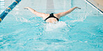 Fitness, swimming pool and woman athlete training for a race, competition or tournament. Sports, workout and back of female swimmer practicing a cardio water skill for exercise, speed or endurance.