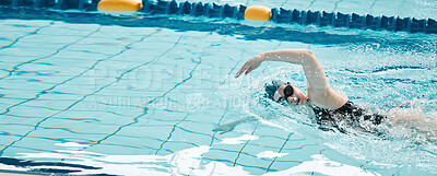 Sports, swimming and woman athlete training for a race, competition or tournament in a pool. Fitness, workout and female swimmer practicing a cardio water skill for exercise, speed or endurance.