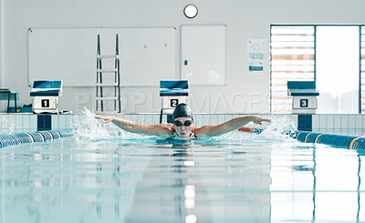 Pool, water splash and sports person swimming, training and practice challenge, fitness or workout routine in gym. Swimmer stroke, commitment and athlete cardio, race competition or match action