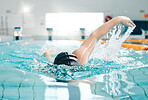 Health, swimming pool and woman athlete training for a race, competition or tournament. Fitness, sports and female swimmer practicing a cardio water skill for exercise, speed or endurance workout.