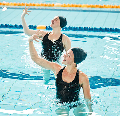 Synchronized, swimming and women in competition performance, event or dance together in pool, water or sport. Athlete, swimmer and people training for concert, dancing or duet or stretching arms