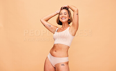 Buy stock photo Happy, lingerie and body of woman in studio isolated on a brown background mockup space. Smile, underwear and model in natural beauty, self love and confidence for positivity, health and wellness