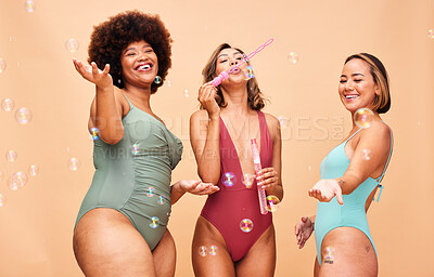 Buy stock photo Blowing bubbles, woman and summer party with inclusion of friends in studio background or swimming, fashion or swimsuit body. Group, playing and diversity of women beauty on fun vacation or skincare