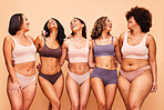 Body positive, happy and women in studio in underwear for wellness, beauty and self love campaign. Diversity, natural skin and people in lingerie on brown background for confident, pride or inclusion