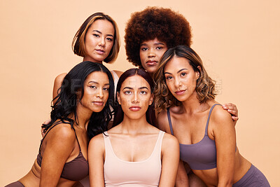 Buy stock photo Diversity, beauty and portrait, group of women with self love and solidarity in studio together. Cosmetics on face, power people on beige background with underwear, skincare and makeup for equality.