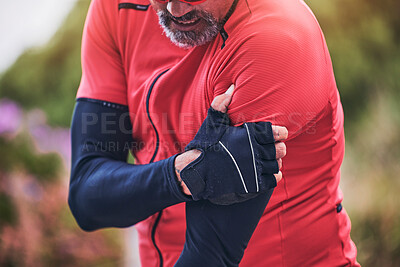 Buy stock photo Man, cyclist and arm injury in sports accident, emergency or broken bone on mountain road in nature. Closeup of male person or athlete with sore pain, ache or joint inflammation from cycling or fall