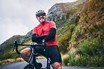 Portrait, cycling and arms crossed with man in nature for sports, training and challenge. Exercise, workout and health with mature person on bike in mountains for energy, freedom and performance