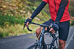 Fitness, cycling and hands with person on bike in nature for sports, training or challenge. Exercise, workout and health with closeup of man on bicycle in mountains for energy, freedom or performance