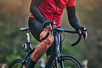 Sports, cycling and hands with person on bike in nature for fitness, training or challenge. Exercise, workout and health with closeup of man on bicycle in mountains for energy, freedom or performance