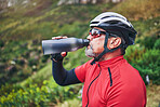 Man, cyclist and drinking water on mountain in fitness, diet or natural nutrition in rest or break after cycling exercise. Thirsty male person with mineral drink for sustainability in cardio training