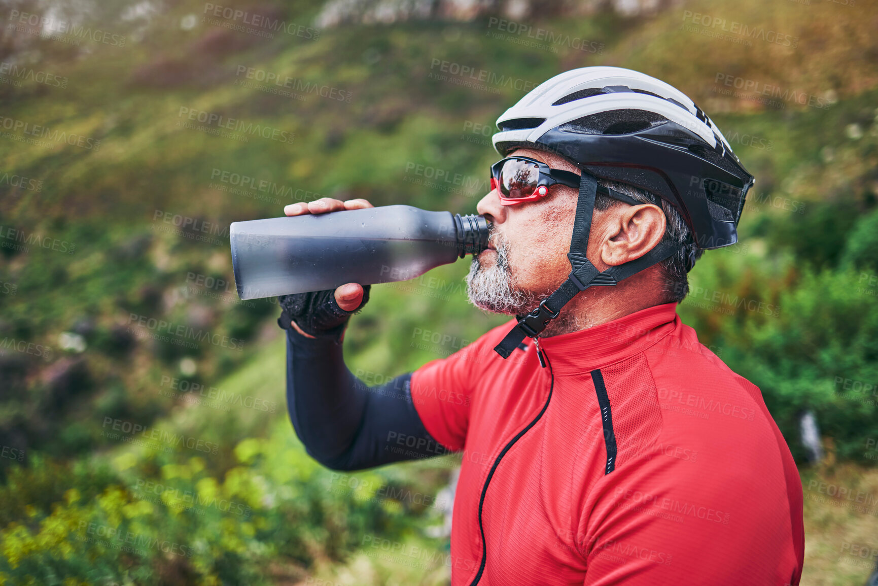 Buy stock photo Man, cyclist and drinking water on mountain in fitness, diet or natural nutrition in rest or break after cycling exercise. Thirsty male person with mineral drink for sustainability in cardio training