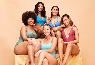 Buy stock photo Portrait, swimwear and group of women in studio isolated on a brown background. Happy, bikini and friends with body positivity, inclusion or wellness for diversity in summer fashion at beach vacation