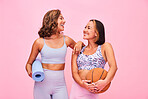 Sports, fitness and women on pink background for yoga, training and exercise with ball and yogi mat. Friends, happy and people in studio with gym equipment for wellness, workout and healthy body