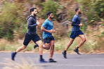Men, fitness and running friends in a road for training, speed and energy, health and cardio routine in nature. Sports, diversity and man group on practice run for competition, workout or performance