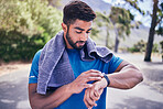 Pulse check, man and fitness watch with training results, towel and time monitoring of run outdoor. Runner, workout app, heart rate and athlete progress for sport and exercise on a road for health